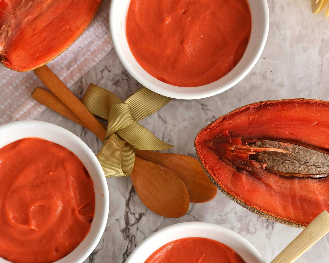 Mamey Zapote pulp in white bowls beside a halved mamey